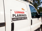 A white utility van with a custom business sign on the side door that reads 'LUMNER PLAMINES' and 'LAND AGETE SERE COTB', with a small orange lion logo above. The photo is taken outdoors with trees and sky blurred in the background.